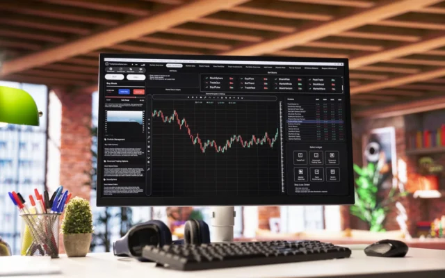 Laptop showing a falling price chart, illustrating the question are NFTs dead in 2026